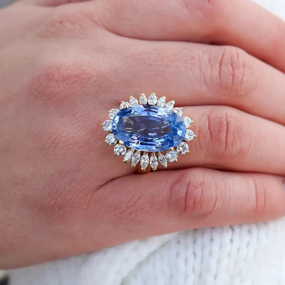 Large Oval Blue Sapphire with Round and Marquise Diamond Halo Style Ring
