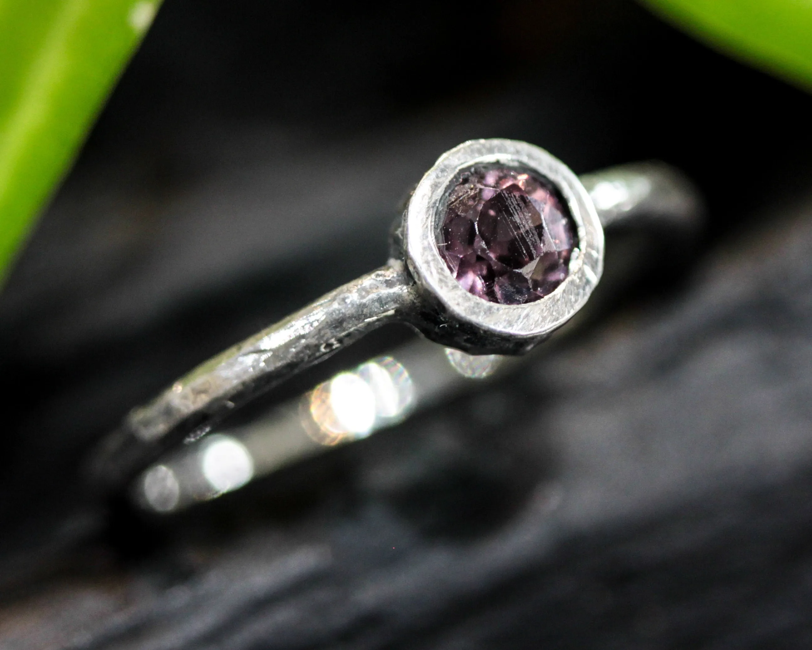 Round cut pink spinel ring in bezel setting with sterling silver texture band